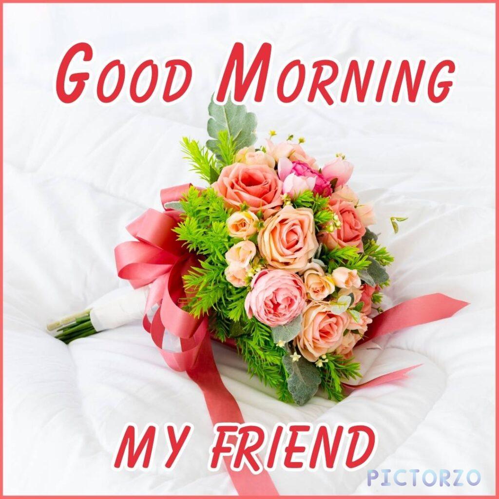 A bouquet of mixed flowers in a vase on a white table, with the text Good morning my friend! written on it