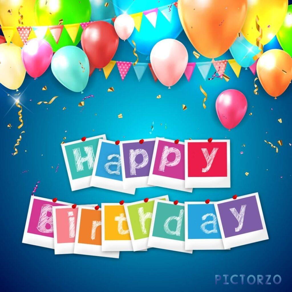 A close-up of a colorful happy birthday card with balloons and confetti. The card has a blue background with the text "Happy Birthday" in yellow letters. There are three balloons in the card: a red balloon, a green balloon, and a blue balloon. The balloons are tied to the bottom of the card with a thin, red ribbon. There is also confetti scattered around the balloons.