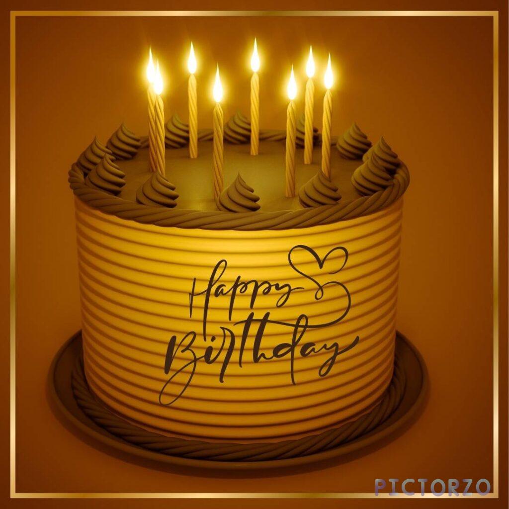 A close-up photo of a round birthday cake with candles on a brown background. The cake is decorated with a heart, a Happy Birthday message, and colorful sprinkles