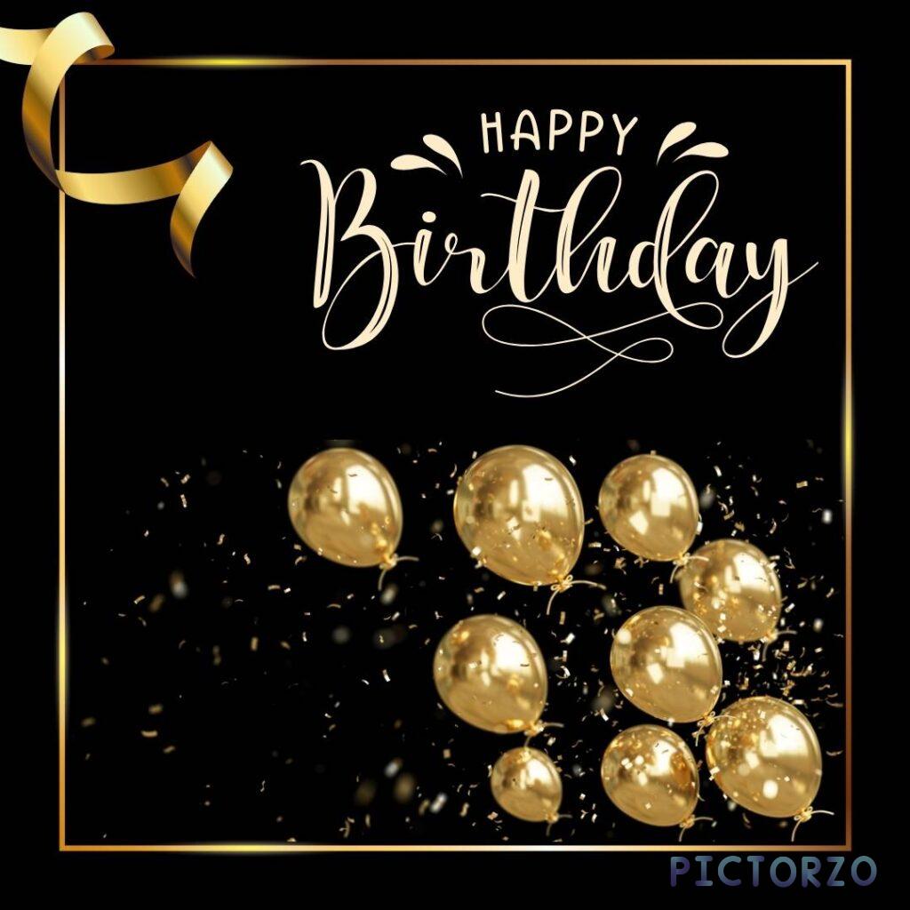 A close-up view of a black greeting card with the gold balloon Happy Birthday surrounded by a cluster of vibrant balloons in various shapes and colors
