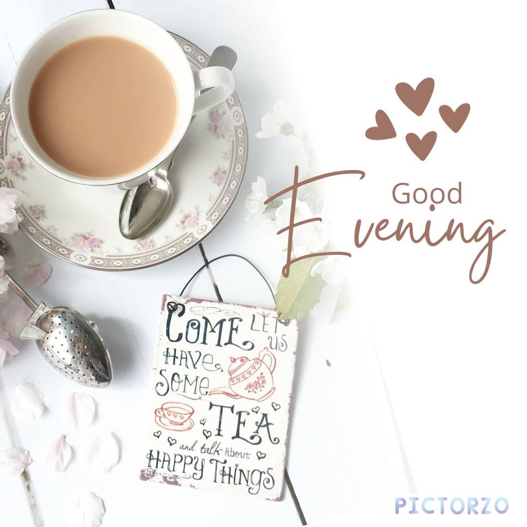 A cup of tea sitting on top of a saucer, with the text "Good evening! Come have some tea and talk about happy things" above it. The teacup is on a wooden table in front of a retro metal hanging sign that says "Sass Belle Retro Come Lets Have Some Tea