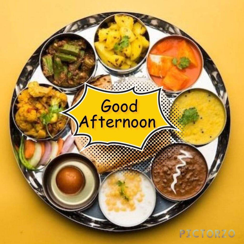 A delicious and nutritious Indian vegetarian thali meal, perfect for a good afternoon lunch. The thali includes rice, dal, naan bread, and a variety of curries, all served on a round metal tray