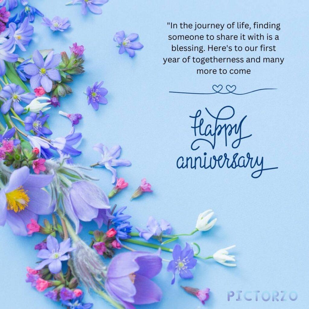 A digital illustration with purple flowers in the background. The text "In the journey of life, finding someone to share it with is a blessing. Here's to our first year of togetherness and many more to come. Happy Anniversary" is written in white in the foreground.