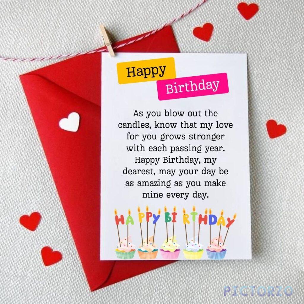 A happy birthday card with a loving message written inside. The message reads: "Happy Birthday, as you blow out the candles, know that my love for you grows stronger with each passing year. Happy Birthday, my dearest, may your day be as amazing as you make mine every day