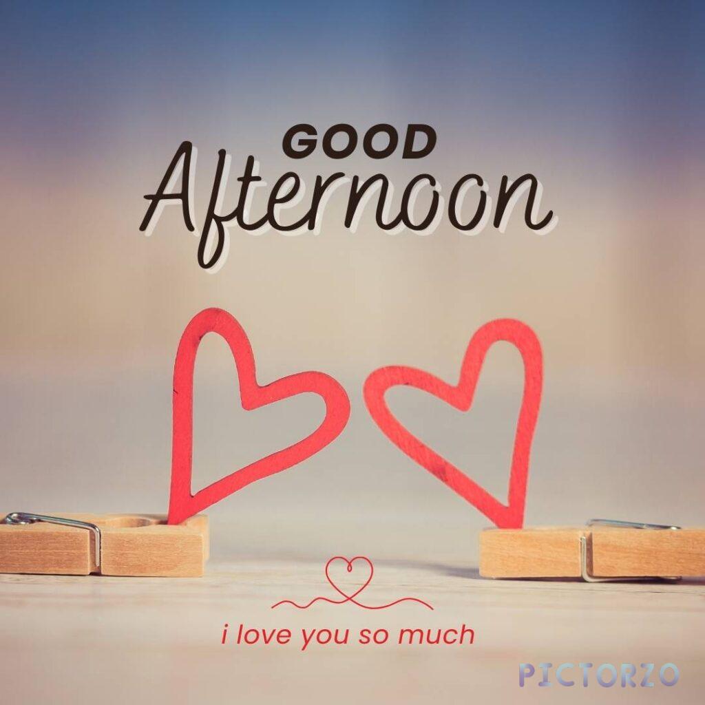 A photo of two red hearts on wooden clothespins with the text Good afternoon, I love you so much. The hearts are hung on a clothesline in front of a white background.
