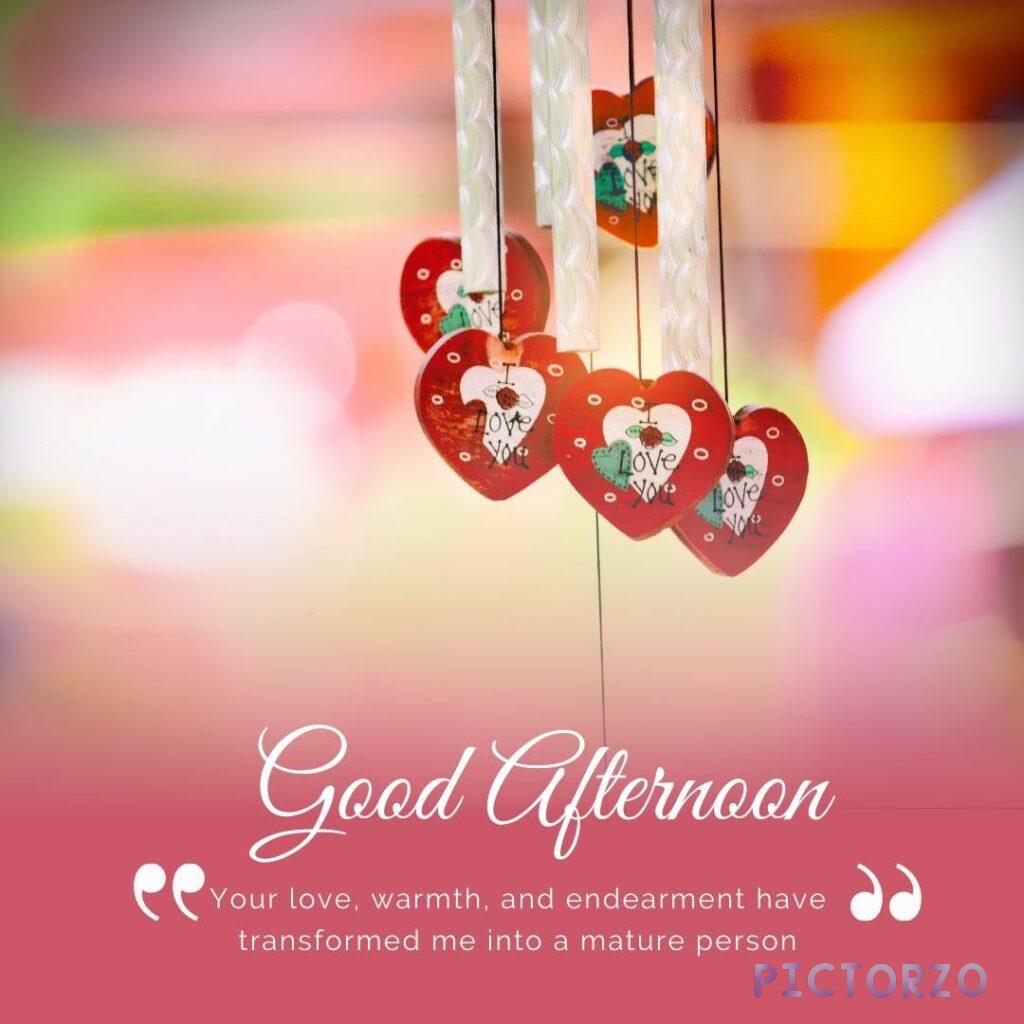 A pink background with wind chimes and hearts. The text Good afternoon, your love, warmth, and endearment have transformed me into a mature person is written in the center of the image.