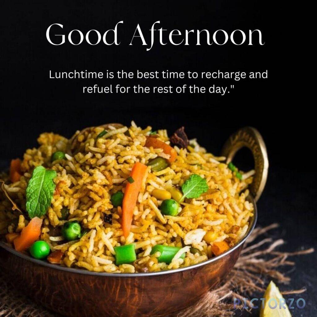 A plate of biryani rice with vegetables, spices, and herbs. The dish is garnished with cilantro and mint leaves. The text "Good Afternoon Lunchtime is the best time to recharge and refuel for the rest of the day" is superimposed on the image.