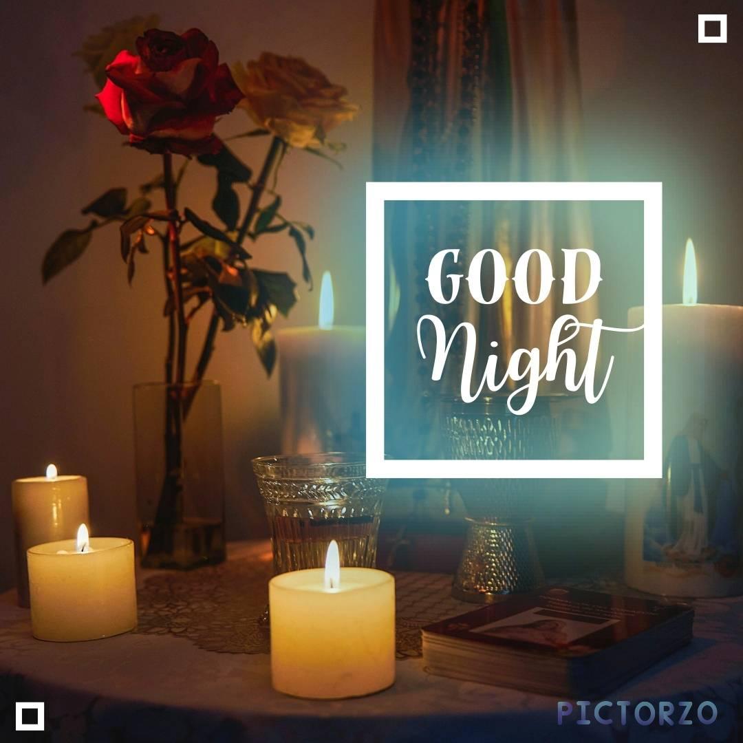 Image of a table with a bunch of lit candles, a vase of roses, and the text GOOD Night in the background