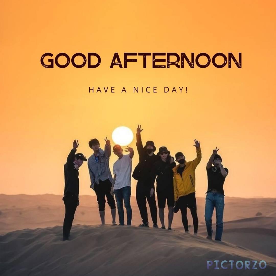 many friends are standing on the desert mountain clicking cool photos in front of the camera with the sun sitting in the background and text is good afternoon have a nice day on it